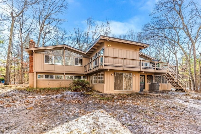 rear view of property with a wooden deck and central air condition unit