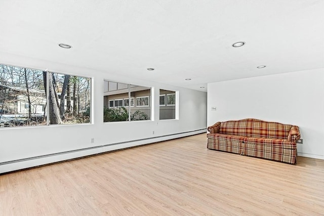 living area featuring a baseboard radiator and light wood-type flooring