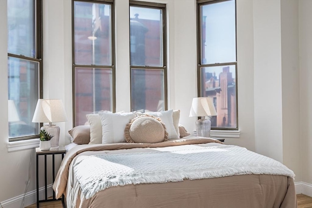 bedroom featuring baseboards and wood finished floors
