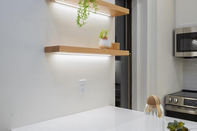 kitchen with decorative backsplash and appliances with stainless steel finishes