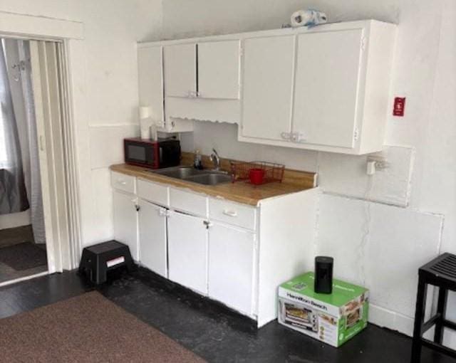 1098 Pleasant St, Palmer, MA 01069 - kitchen featuring black microwave, a sink, and white cabinetry