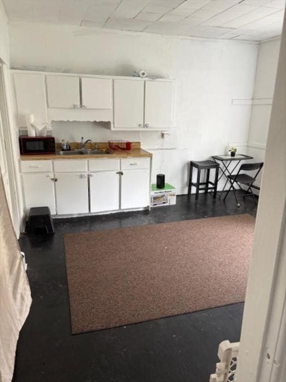 1098 Pleasant St, Palmer, MA 01069 - kitchen featuring a sink, black microwave, and white cabinets