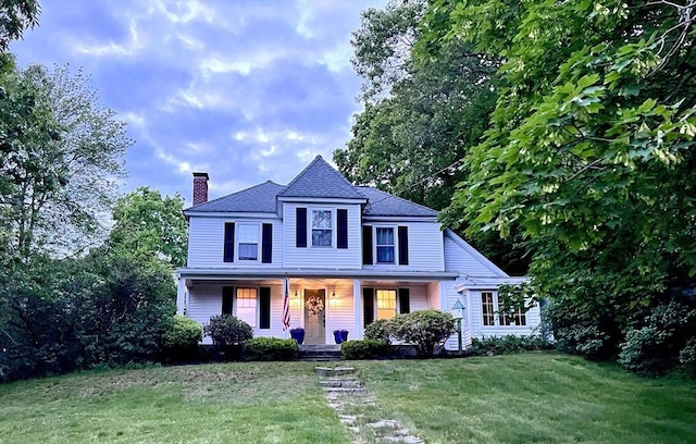 24 Summit Ave, Chelmsford, MA 01824 - view of front of home featuring a chimney, a porch, a front yard, and a shingled roof
