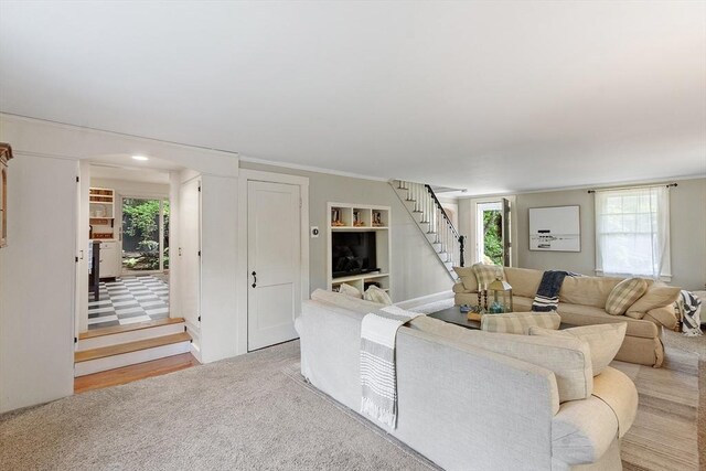 24 Summit Ave, Chelmsford, MA 01824 - carpeted living area with healthy amount of natural light, stairs, and arched walkways