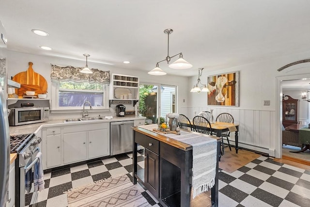 24 Summit Ave, Chelmsford, MA 01824 - kitchen with stainless steel appliances, a sink, light floors, a baseboard radiator, and light countertops