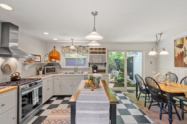 24 Summit Ave, Chelmsford, MA 01824 - kitchen featuring stainless steel appliances, a sink, wall chimney range hood, tile patterned floors, and healthy amount of natural light