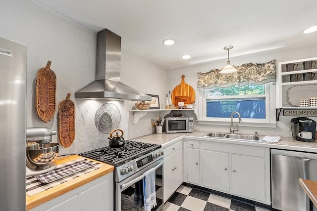 24 Summit Ave, Chelmsford, MA 01824 - kitchen featuring stainless steel appliances, wall chimney range hood, a sink, tile patterned floors, and light countertops