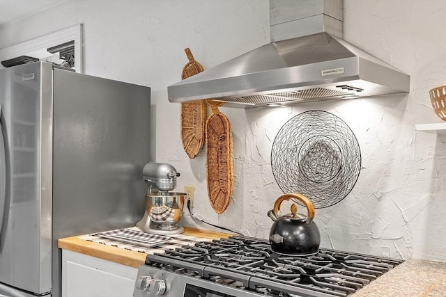 24 Summit Ave, Chelmsford, MA 01824 - kitchen featuring wall chimney exhaust hood, stainless steel appliances, white cabinets, and butcher block counters