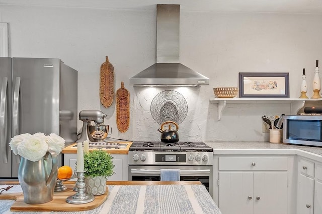 24 Summit Ave, Chelmsford, MA 01824 - kitchen with appliances with stainless steel finishes, wall chimney exhaust hood, white cabinetry, and light countertops
