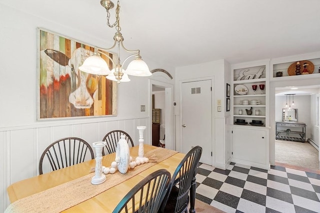 24 Summit Ave, Chelmsford, MA 01824 - dining space featuring tile patterned floors, wainscoting, built in shelves, and a chandelier