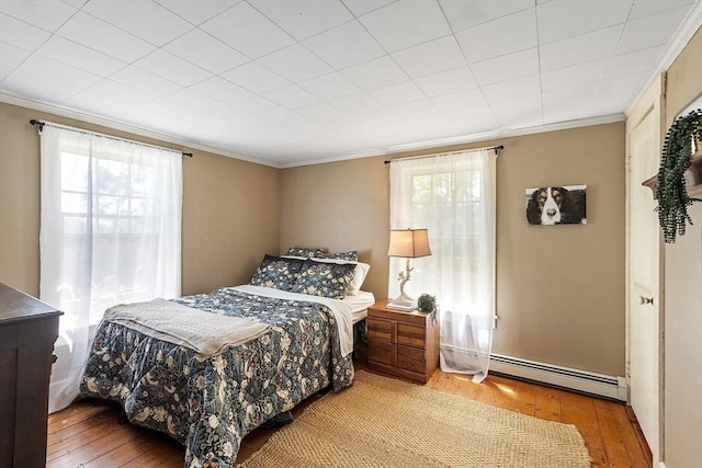 24 Summit Ave, Chelmsford, MA 01824 - bedroom featuring a baseboard radiator, hardwood / wood-style flooring, ornamental molding, and multiple windows
