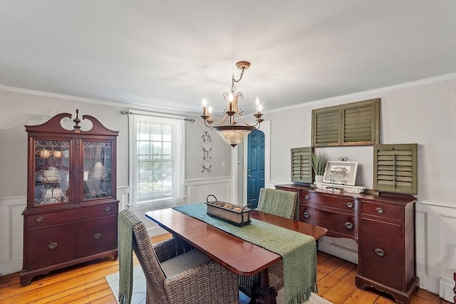24 Summit Ave, Chelmsford, MA 01824 - dining space featuring a chandelier, light wood-style flooring, crown molding, a decorative wall, and a wainscoted wall