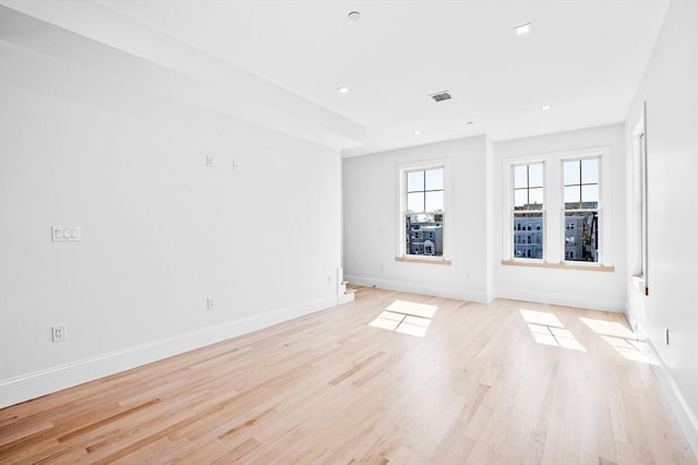 empty room featuring baseboards, light wood finished floors, and recessed lighting