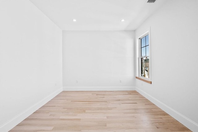 unfurnished room featuring baseboards, light wood finished floors, recessed lighting, and visible vents