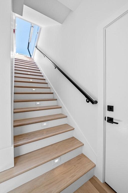 stairway featuring wood finished floors