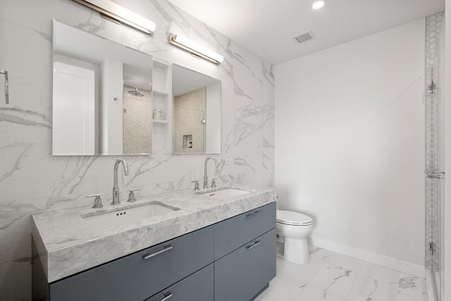 bathroom with walk in shower, vanity, and toilet