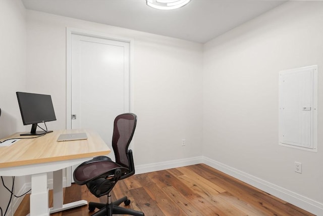 home office featuring wood-type flooring and electric panel