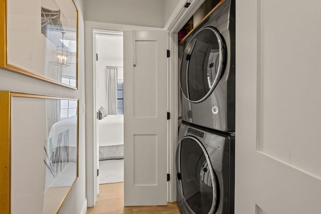350 Bradford St Unit 7, Provincetown, MA 02657 - laundry room with estacked washer and dryer and light wood-type flooring
