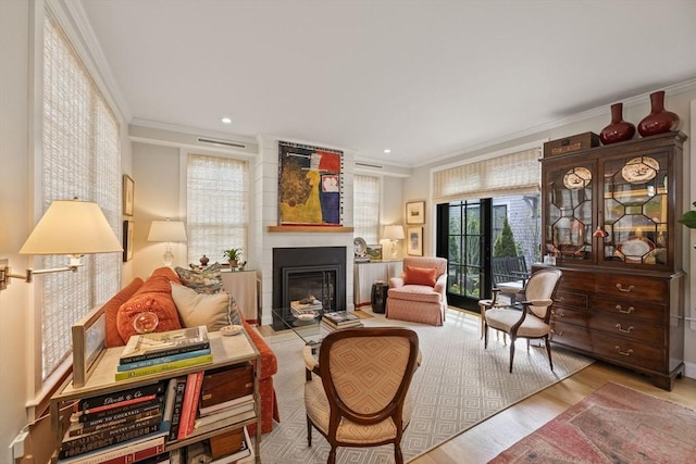 350 Bradford St Unit 7, Provincetown, MA 02657 - living room with crown molding, a glass covered fireplace, wood finished floors, and recessed lighting