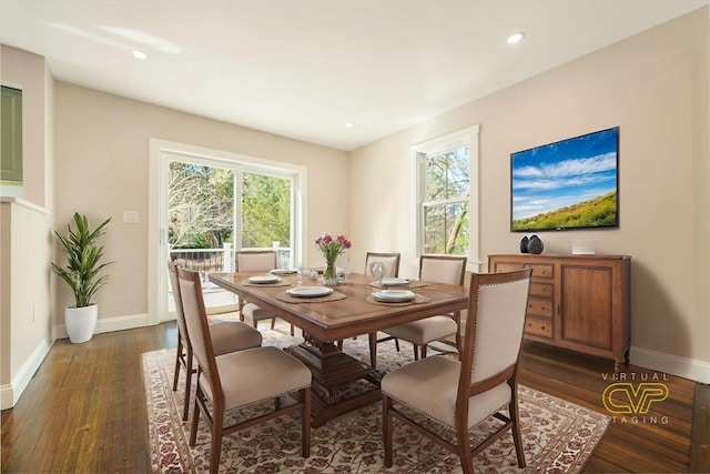 dining room with a wealth of natural light, dark wood-type flooring, and baseboards