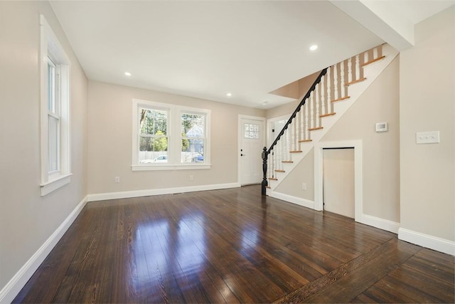 unfurnished living room featuring recessed lighting, stairway, baseboards, and hardwood / wood-style flooring