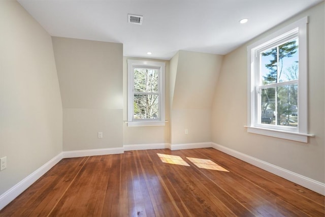 spare room with recessed lighting, visible vents, wood-type flooring, and baseboards