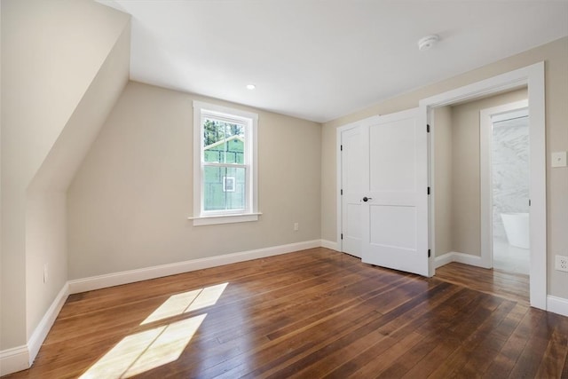 bonus room featuring hardwood / wood-style flooring, baseboards, and lofted ceiling