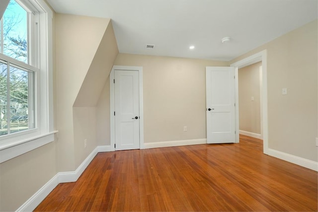 bonus room featuring visible vents, recessed lighting, baseboards, and wood finished floors