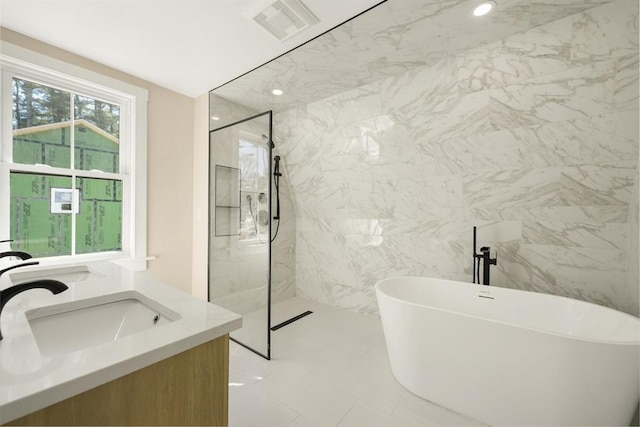 bathroom featuring vanity, visible vents, a marble finish shower, a freestanding tub, and recessed lighting