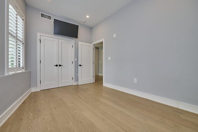 unfurnished bedroom with light wood-style floors, baseboards, and recessed lighting