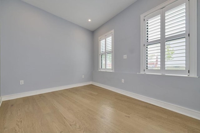 unfurnished room with light wood-type flooring, baseboards, and recessed lighting