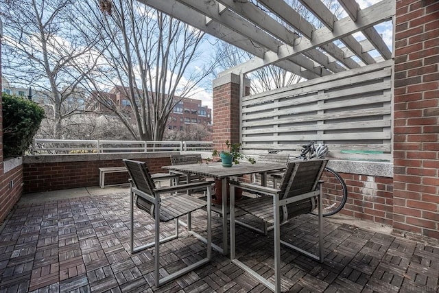 view of patio / terrace with a pergola and outdoor dining area