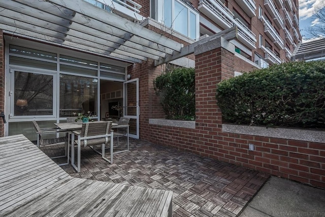 view of patio with a pergola and outdoor dining area