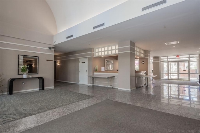 lobby featuring a towering ceiling