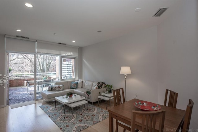 living area featuring wood finished floors and recessed lighting