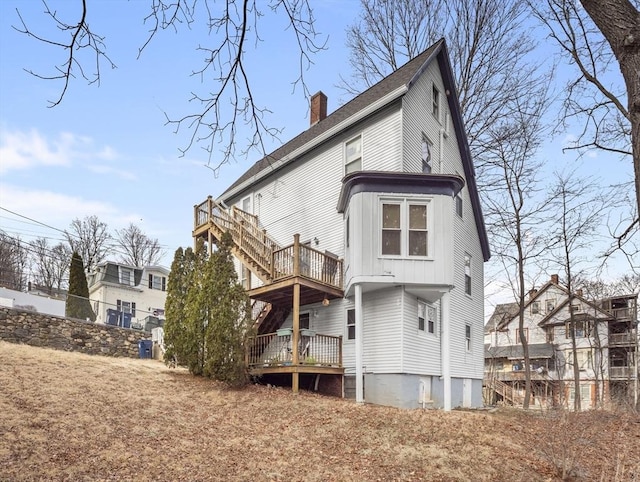 back of property with a wooden deck