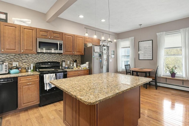 89 Plymouth St Unit 2, Cambridge, MA 02141 - kitchen featuring black appliances, light wood finished floors, backsplash, light stone counters, and recessed lighting