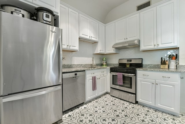 kitchen featuring white cabinetry, light stone countertops, stainless steel appliances, and sink