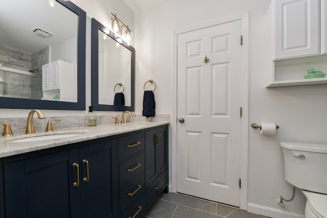 bathroom featuring vanity, toilet, tile patterned floors, and walk in shower