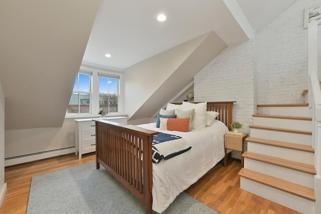 bedroom with hardwood / wood-style flooring and baseboard heating