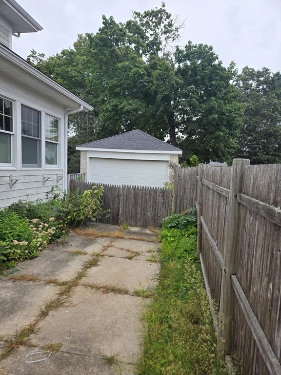 view of yard with fence and a detached garage