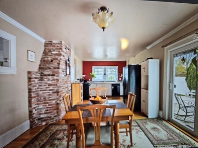 dining area with ornamental molding and wood-type flooring