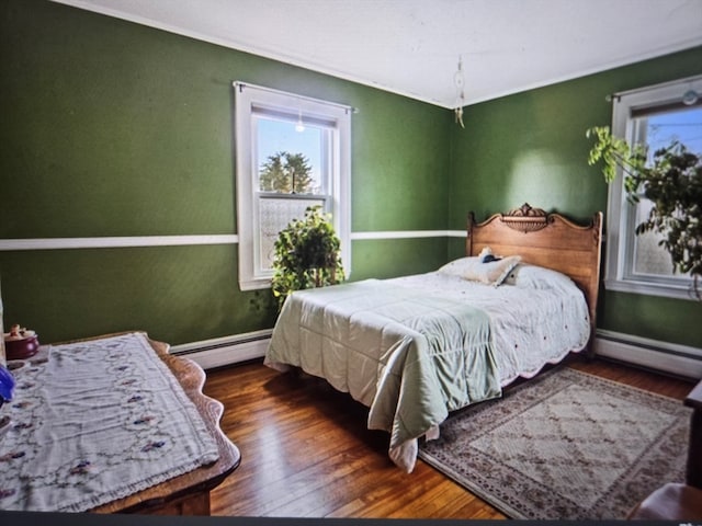 bedroom featuring dark wood-type flooring and baseboard heating