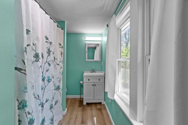 31 Brookside Dr, North Smithfield, RI 02896 - bathroom with wood finished floors, vanity, baseboards, and a shower with shower curtain