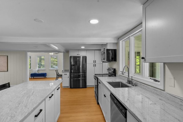 31 Brookside Dr, North Smithfield, RI 02896 - kitchen featuring black appliances, a sink, light wood-style floors, light stone countertops, and white cabinets