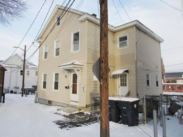 view of snow covered rear of property