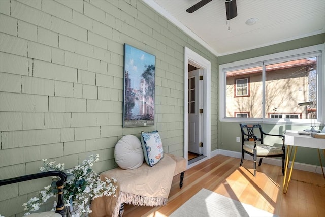 home office with ceiling fan, baseboards, wood finished floors, and ornamental molding