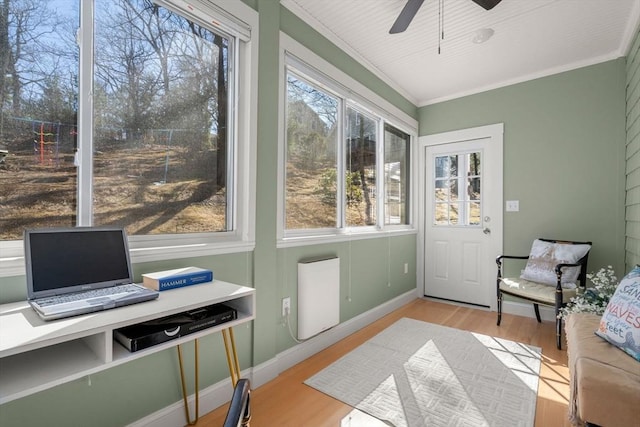 sunroom / solarium with a ceiling fan