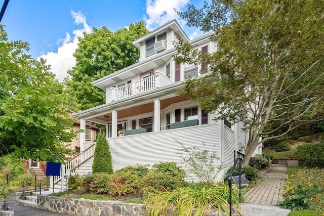 american foursquare style home featuring stairway and a balcony