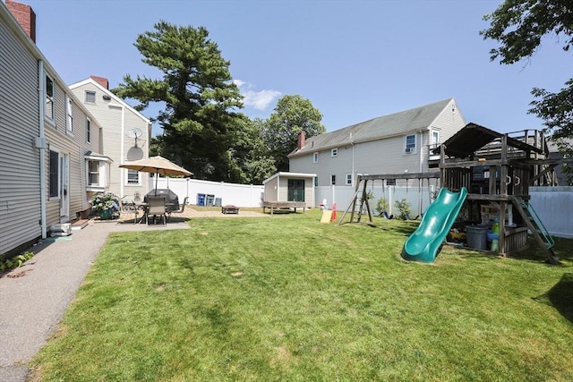 137 High St, Danvers, MA 01923 - fenced backyard featuring a playground, a patio area, and an outdoor structure